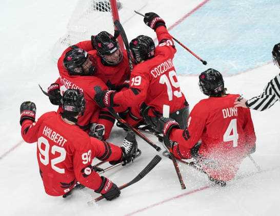 (260316) -- MILAN, March 16, 2026 -- Players of Canada celebrate a goal during the Para Ice hockey, Eishockey final match between the United States and Canada at the Milan-Cortina 2026 Paralympic Winter games, Winterspiele,Spiele, Summer games in Milan, Italy, March 15, 2026. ) (SP)ITALY-MILAN-CORTINA 2026-PARALYMPIC WINTER GAMES-PARA ICE HOCKEY-USA VS CANADA LixJing 