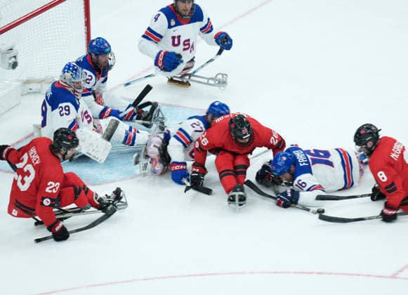 (260316) -- MILAN, March 16, 2026 -- Players of the United States and Canada compete during the Para Ice hockey, Eishockey final match between the United States and Canada at the Milan-Cortina 2026 Paralympic Winter games, Winterspiele,Spiele, Summer games in Milan, Italy, March 15, 2026. ) (SP)ITALY-MILAN-CORTINA 2026-PARALYMPIC WINTER GAMES-PARA ICE HOCKEY-USA VS CANADA LixJing 