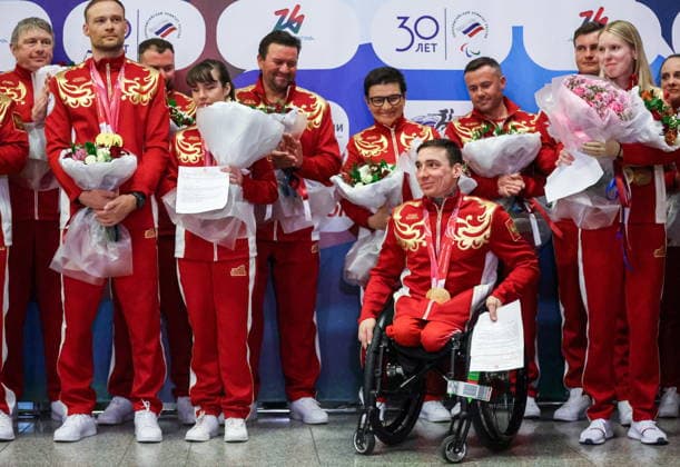 RUSSIA, MOSCOW - MARCH 17, 2026: Para cross-country skier Ivan Golubkov (R front) is seen during a welcoming ceremony for Russian athletes returning home after the 2026 Winter Paralympic Games, at Moscow’s Vnukovo International Airport. The Russian team scored third in the overall medal standings, bringing home the total of 12 medals (8 gold, 1 silver and 3 bronze). Yevgeny Messman TASS  90153336
