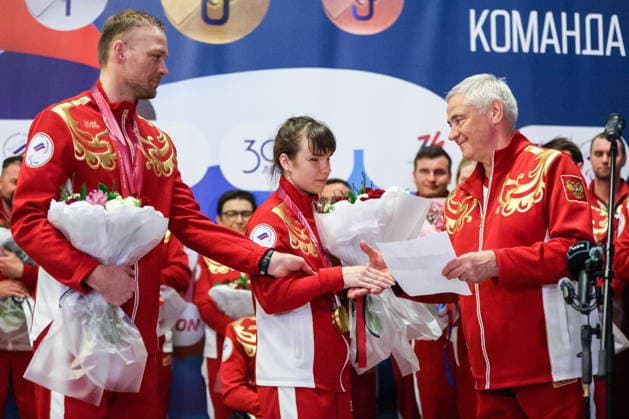 RUSSIA, MOSCOW - MARCH 17, 2026: President of the Russian Paralympic Committee Pavel Rozhkov, para cross-country skier Anastasia Bagiian, and her guide Sergei Siniakin (R-L) are seen during a welcoming ceremony for Russian athletes returning home after the 2026 Winter Paralympic Games, at Moscow’s Vnukovo International Airport. The Russian team scored third in the overall medal standings, bringing home the total of 12 medals (8 gold, 1 silver and 3 bronze). Yevgeny Messman TASS  90153389