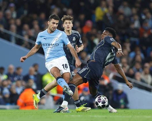 Manchester, England, 17th March 2026. Rodri of Manchester City tackled by Aurelien Tchouameni of Real Madrid during the Manchester City vs Real Madrid UEFA Champions League round of 16 match at the Etihad Stadium, Manchester. Picture credit should read: Cody Froggatt Sportimage EDITORIAL USE ONLY. No use with unauthorised audio, video, data, fixture lists, club league logos or live services. Online in-match use limited to 120 images, no video emulation. No use in betting, games or single club league player publications. SPI_015_CF_ManCity_Madrid SPI-4612-0037