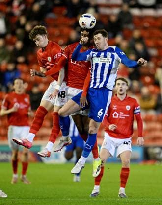 Scott Banks and Vimal Yoganathan of Barnsley challenge Jensen Weir of Wigan Athletic Barnsley v Wigan Athletic, Sky Bet League One, Football, Oakwell, Barnsley, UK - 17 Mar 2026Barnsley Oakwell United Kingdom EDITORIAL USE ONLY No use with unauthorised audio, video, data, fixture lists, club league logos or live services. Online in-match use limited to 120 images, no video emulation. No use in betting, games or single club league player publications. Copyright: xAnnaxGowthorpe Shutterstockx 16776372q