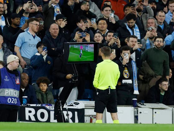 Manchester, England, 17th March 2026. Referee Clement Turpin looks at the VAR camera during the Manchester City vs Real Madrid UEFA Champions League round of 16 match at the Etihad Stadium, Manchester. Picture credit should read: Cody Froggatt Sportimage EDITORIAL USE ONLY. No use with unauthorised audio, video, data, fixture lists, club league logos or live services. Online in-match use limited to 120 images, no video emulation. No use in betting, games or single club league player publications. SPI_021_CF_ManCity_Madrid SPI-4612-0046