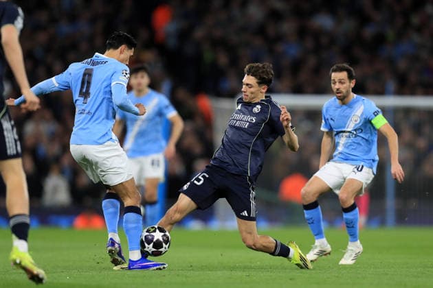 17th March 2026; Etihad Stadium, Manchester, England; UEFA Champions League Football, Manchester City versus Real Madrid; Tijjani Reijnders of Manchester City tackles Arda Guler of Real Madrid  DavidxBlunsden Content restricted for UK based newspaper