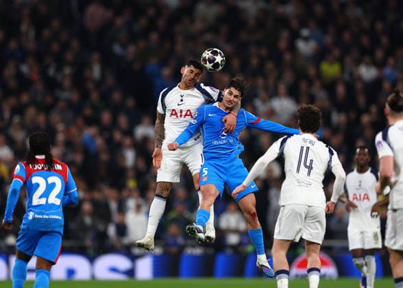 18th March 2026; Tottenham Hotspur Stadium, London, England; UEFA Champions League Football, Tottenham Hotspur versus Atletico Madrid; Cristian Romero of Tottenham Hotspur heads the ball over Johnny Cardoso of Atletico Madrid  JPxFletcher Content restricted for UK based newspaper