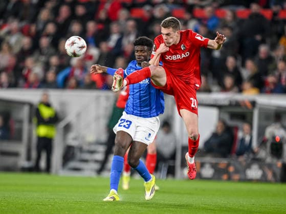 Aaron Bibout (KRC Genk) and Matthias Ginter (SC Freiburg) battle for the ball during the UEFA Europa League 2025 26 Round of 16 Second Leg match between SC Freiburg and KRC Genk at Stadion am Wolfswinkel on March 19, 2026 in Freiburg im Breisgau, Germany. (Photo by Harry Langer DeFodi Images) -