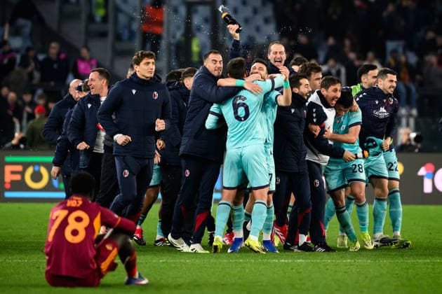 Bologna players celebrate while Robinio Vaz of AS Roma looks dejected at the end of the UEFA Europa League 2025 2026 football match between AS Roma and Bologna FC 1909 at Stadio Olimpico in Roma (Italy), March 19, 2026. andreaxstaccioli