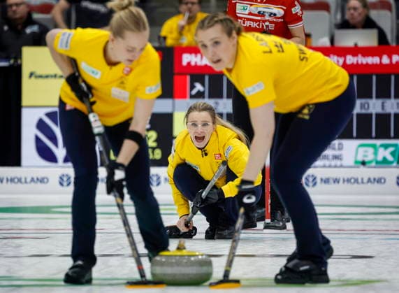 March 19, 2026, Calgary, Ab, CANADA: Sweden skip Isabella Wranaa, centre, delivers a stone against the Turkey as lead Linda Stenlund, left, and second Maria Larsson sweep at the World Women s Curling Championship in Calgary, Thursday, March 19, 2026. Isabella Wranaa, Linda Stenlund, Maria Larsson  - ZUMAc35_ 20260319_zaf_c35_047 Copyright: xJeffxMcintoshx