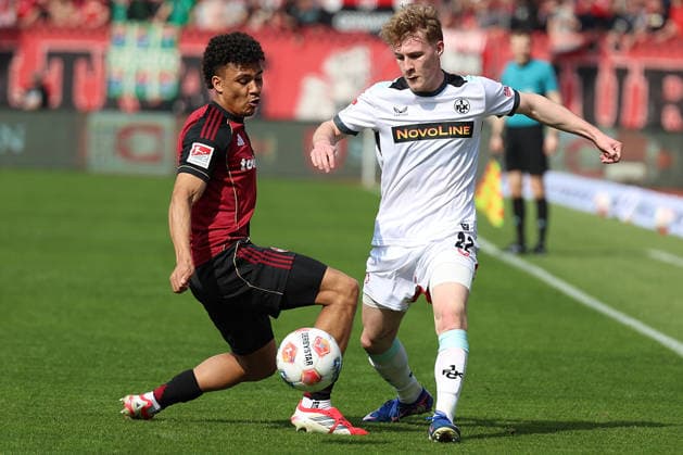 21.03.2026, xrekx, Fussball 2.Bundesliga, 1. FC Nuernberg - 1.FC Kaiserslautern v.l. Henri Koudossou (1.FC Nuernberg) Mika Haas (1.FC Kaiserslautern) Zweikampf, Aktion, action, battle for the ball (DFL DFB REGULATIONS PROHIBIT ANY USE OF PHOTOGRAPHS as IMAGE SEQUENCES and or QUASI-VIDEO) Nuernberg