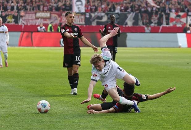 21.03.2026 - Fussball - Saison 2025 2026 - 2. Fussball - Bundesliga - 27. Spieltag: 1. FC Nürnberg FCN ( Club ) - 1. FC Kaiserslautern FCK ( Rote Roten Teufel ) - Sportfoto Zink DaMa - xdaxmax - DFL regulations prohibit any use of photographs as image sequences and or quasi-video - only for editorial use - Mika Haas (22, 1. FC Kaiserslautern FCK ) Henri Koudossou (8, 1. FC Nürnberg FCN )