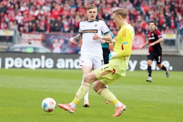 21.03.2026, xrekx, Fussball 2.Bundesliga, 1. FC Nuernberg - 1.FC Kaiserslautern v.l. Norman Bassette (1.FC Kaiserslautern) Jan Reichert (1.FC Nuernberg) (DFL DFB REGULATIONS PROHIBIT ANY USE OF PHOTOGRAPHS as IMAGE SEQUENCES and or QUASI-VIDEO) Nuernberg