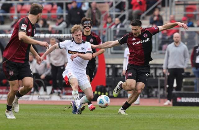 21.03.2026 - Fussball - Saison 2025 2026 - 2. Fussball - Bundesliga - 27. Spieltag: 1. FC Nürnberg FCN ( Club ) - 1. FC Kaiserslautern FCK ( Rote Roten Teufel ) - Sportfoto Zink DaMa - xdaxmax - DFL regulations prohibit any use of photographs as image sequences and or quasi-video - only for editorial use - Mika Haas (22, 1. FC Kaiserslautern FCK ) Luka Lochoshvili (24, 1. FC Nürnberg FCN )