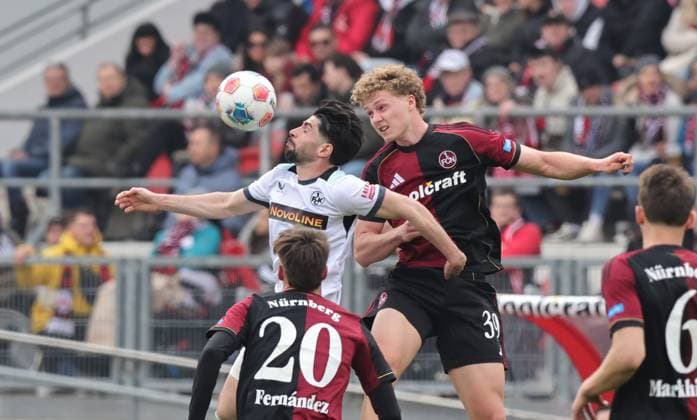 21.03.2026 - Fussball - Saison 2025 2026 - 2. Fussball - Bundesliga - 27. Spieltag: 1. FC Nürnberg FCN ( Club ) - 1. FC Kaiserslautern FCK ( Rote Roten Teufel ) - Sportfoto Zink DaMa - xdaxmax - DFL regulations prohibit any use of photographs as image sequences and or quasi-video - only for editorial use - Semih Sahin (8, 1. FC Kaiserslautern FCK ) im Kopfballduell mit Piet Scobel (39, 1. FC Nürnberg FCN )