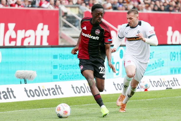 21.03.2026, xrekx, Fussball 2.Bundesliga, 1. FC Nuernberg - 1.FC Kaiserslautern v.l. Rabby Nzingoula (1.FC Nuernberg) Luca Sirch (1.FC Kaiserslautern) Zweikampf, Aktion, action, battle for the ball (DFL DFB REGULATIONS PROHIBIT ANY USE OF PHOTOGRAPHS as IMAGE SEQUENCES and or QUASI-VIDEO) Nuernberg