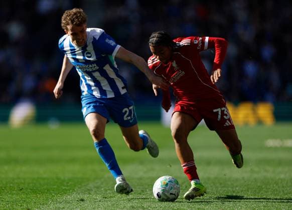 Rio Ngumoha of Liverpool is chased by Mats Wieffer of Brighton and Hove Albion Brighton and Hove Albion v Liverpool, Premier League, Football, American Express Community Stadium, Brighton, UK - 21 Mar 2026Brighton American Express Community Stadi United Kingdom EDITORIAL USE ONLY No use with unauthorised audio, video, data, fixture lists, club league logos or live services. Online in-match use limited to 120 images, no video emulation. No use in betting, games or single club league player publications. Copyright: xWillxCooper Shutterstockx 16783233bb