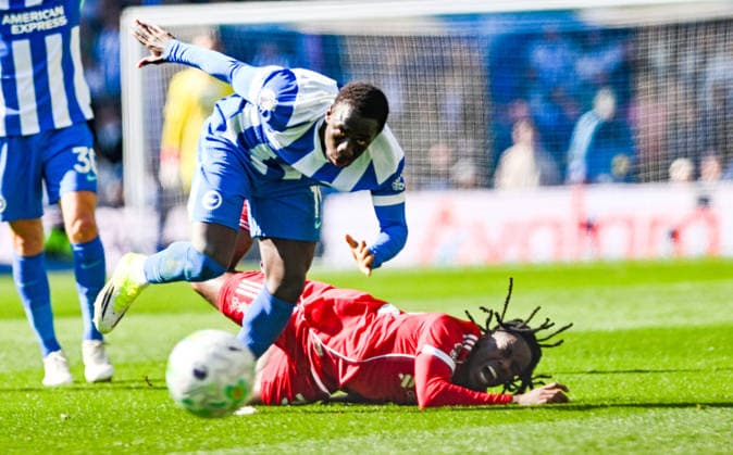 Yankuba Minteh of Brighton fouls Jeremie Frimpong of Liverpool during the Premier League match between Brighton and Hove Albion and Liverpool at the American Express Stadium , Brighton , UK - 21st March 2026 Brighton & Hove Albion vs Liverpool Premier League Football, Amex Stadium, Sussex, United Kingdom - 21 Mar 2026Brighton Amex Stadium Sussex United Kingdom Editorial use only. No merchandising. For Football images FA and Premier League restrictions apply inc. no internet mobile usage without FAPL license - for details contact Football Dataco  Copyright: xSimonxDack TPI Shutterstockx 16784403aa