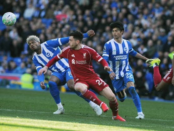 Football - 2025 2026 Premier League - Brighton & Hove Albion vs. Liverpool - the Amex (Falmer Stadium) - Saturday 21st March 2026 Georginio Rutter and Kaoru Mitoma of Brighton challenge Andy Robertson 
