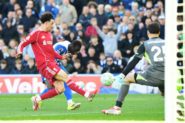 Brighton and Hove Albion v Liverpool, Premier League Giorgi Mamardashvili Goalkeeper of Liverpool looks on as Curtis Jones Midfielder of Liverpool prevents the headed attempt on goal by Yankuba Minteh Forward of Brighton and Hove Albion during the Premier League match between Brighton and Hove Albion and Liverpool at the American Express Stadium, Brighton and Hove, UK on 21 March 2026. Brighton and Hove American Express Stadium East Sussex UK Editorial use only DataCo restrictions apply See www.football-dataco.com , Copyright: xJeffxMoodx PSI-23949-0032