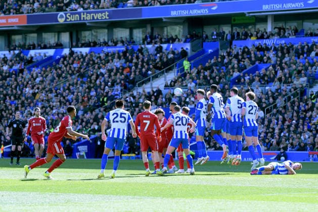 Brighton and Hove Albion v Liverpool, Premier League Brighton players jump to defend the free kick taken by Dominik Szoboszlai Midfielder of Liverpool during the Premier League match between Brighton and Hove Albion and Liverpool at the American Express Stadium, Brighton and Hove, UK on 21 March 2026. Brighton and Hove American Express Stadium East Sussex UK Editorial use only DataCo restrictions apply See www.football-dataco.com , Copyright: xJeffxMoodx PSI-23949-0065