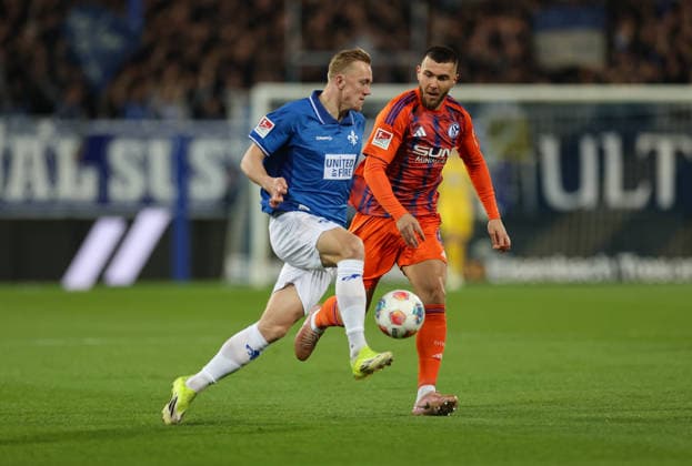 21.03.2026, Fussball 2. Bundesliga, SV Darmstadt 98 - FC Schalke 04, v.l., Isac Lidberg (SV Darmstadt 98), Hasan Kurucay (FC Schalke 04) DFL DFB REGULATIONS PROHIBIT ANY USE OF PHOTOGRAPHS AS IMAGE SEQUENCES AND OR QUASI-VIDEO. xdcx