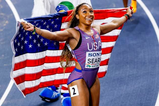 second Jacious Sears of United States of America celebrating and holding flag after Women s 60m Final, World Athletics Indoor Championships Kujawy Pomorze, World Athletics Indoor Championships Kujawy Pomorze, Kujawsko Pomorska Arena Torun, March 21, 2026, Torun, Poland.