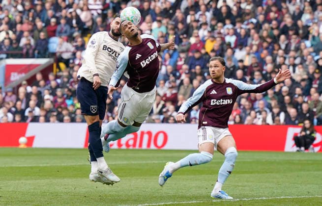Birmingham, England, 22nd March 2026. Valentin Castellanos of West Ham United (L) challenges Ezri Konsa of Aston Villa during the Aston Villa vs West Ham United Premier League match at Villa Park, Birmingham. Picture credit should read: Andrew Yates Sportimage EDITORIAL USE ONLY. No use with unauthorised audio, video, data, fixture lists, club league logos or live services. Online in-match use limited to 120 images, no video emulation. No use in betting, games or single club league player publications. SPI_020_AY_VILLA_WEST_HAM SPI-4635-0020