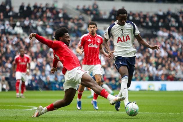 Pape Matar Sarr of Tottenham Hotspur is challenged by Ola Aina of Nottingham Forest Tottenham Hotspur v Nottingham Forest, Football, Premier League, Tottenham Hotspur Stadium, London, UK - 22 03 2026 EDITORIAL USE ONLY No use with unauthorised audio, video, data, fixture lists (outside the EU), club league logos or live services. Online in-match use limited to 45 images (+15 in extra time). No use to emulate moving images. No use in betting, games or Copyright: xAnthonyxHanc Shutterstockx 16785849r