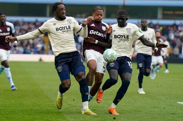 Birmingham, England, 22nd March 2026. Leon Bailey of Aston Villa (C) is challenged by Axel Disasi of West Ham United (L) and El Hadji Malick Diouf of West Ham United during the Aston Villa vs West Ham United Premier League match at Villa Park, Birmingham. Picture credit should read: Andrew Yates Sportimage EDITORIAL USE ONLY. No use with unauthorised audio, video, data, fixture lists, club league logos or live services. Online in-match use limited to 120 images, no video emulation. No use in betting, games or single club league player publications. SPI_034_AY_VILLA_WEST_HAM SPI-4635-0034
