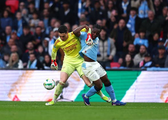 22nd March 2026; Wembley Stadium, London, England; Carabao Cup Final Football, Arsenal versus Manchester City; Goalkeeper Kepa Arrizabalaga of Arsenal pulls back Jeremy Doku of Manchester City  JPxFletcher Content restricted for UK based newspaper