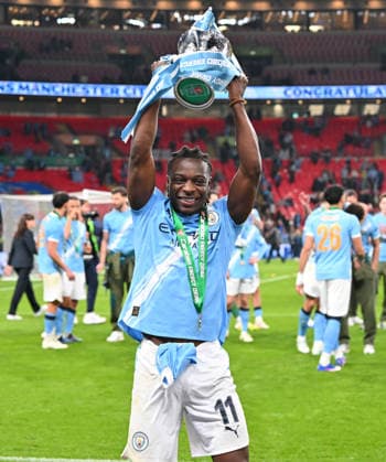 Arsenal v Manchester City, EFL Cup, Cup Final Jeremy Doku (11) of Manchester City celebrates with the trophy during the post match celebrations after the EFL Cup match between Arsenal and Manchester City at Wembley Stadium, London, UK on 22 March 2026. London Wembley Stadium Greater London UK Editorial use only DataCo restrictions apply See www.football-dataco.com , Copyright: xGrahamxHuntx PSI-23937-0124