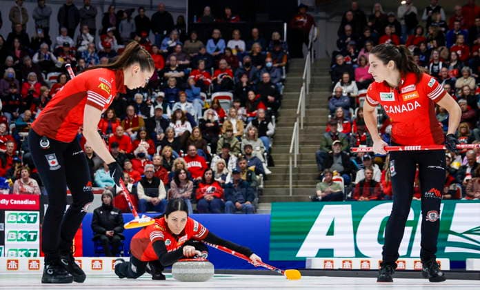 March 22, 2026, Calgary, Ab, CANADA: Team Canada skip Kerri Einarson, centre, delivers a stone against Switzerland as lead Karlee Burgess, left, and second Shannon Birchard sweep during the gold medal draw at the World WomenöÄÃ s Curling Championship in Calgary, Sunday, March 22, 2026. Karlee Burgess, Shannon Birchard, Kerri Einarson - ZUMAc35_ 20260322_zaf_c35_028 Copyright: xJeffxMcintoshx