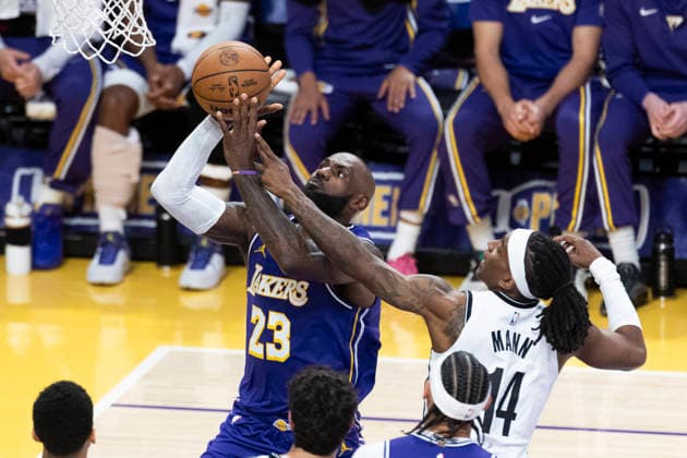 March 27, 2026, Los Angeles, California, USA: Los Angeles LakersÃ¢â‚¬â ¢ LeBron James (23) goes to the basket under pressure from Brooklyn NetsÃ¢â‚¬â ¢ Terance Mann (14) during an NBA, Basketball Herren, USA basketball game at Crypto.com Arena on Friday, March 27, 2026 in Los Angeles. NBA 2026: Nets Vs Lakers  - ZUMAc68_ 20260327_zaf_c68_015 Copyright: xRingoxChiux