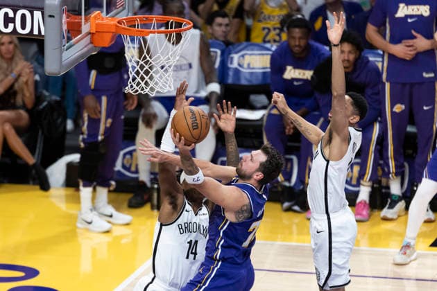 March 27, 2026, Los Angeles, California, USA: Los Angeles LakersÃ¢â‚¬â ¢ Luka DonÄÂiÄ¡ (77) goes to the basket under pressure from Brooklyn NetsÃ¢â‚¬â ¢ Terance Mann (14) during an NBA, Basketball Herren, USA basketball game at Crypto.com Arena on Friday, March 27, 2026 in Los Angeles. NBA 2026: Nets Vs Lakers  - ZUMAc68_ 20260327_zaf_c68_041 Copyright: xRingoxChiux