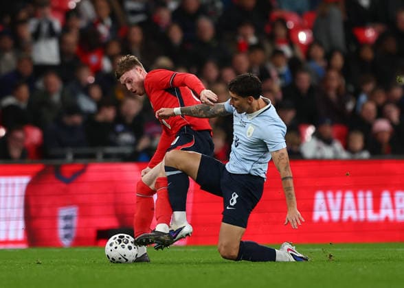 27th March 2026; Wembley Stadium, London, England; Friendly International Football, England versus Uruguay; Cole Palmer of England challenges Emiliano Martinez of Uruguay JPxFletcher