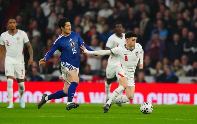 Phil Foden of England holds off Daichi Kamada of Japan England v Japan, International Football, Friendly, Football, Wembley Stadium, London, UK - 31 Mar 2026London Wembley Stadium United Kingdom EDITORIAL USE ONLY No use with unauthorised audio, video, data, fixture lists, club league logos or live services. Online in-match use limited to 120 images, no video emulation. No use in betting, games or single club league player publications. Copyright: xJavierxGarcia Shutterstockx 16808984l