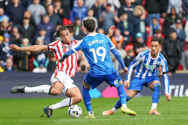 3rd April 2026; Bet365 Stadium, Stoke, Staffordshire, England; EFL Championship Football, Stoke City versus Sheffield Wednesday; Ashley Phillips of Stoke City and Olaf Kobacki of Sheffield Wednesday challenge for the ball AidanxHunter Content restricted for UK based newspaper