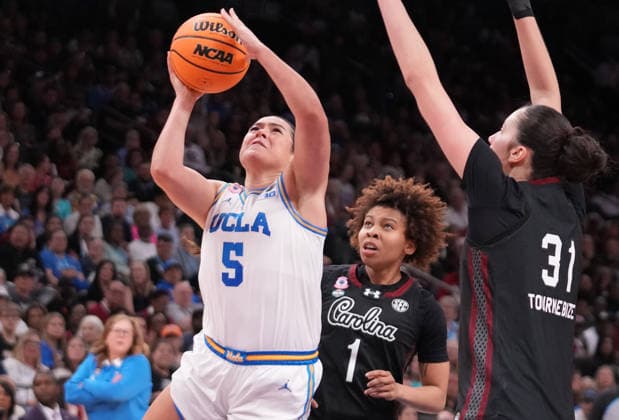 UCLA guard Charlisse Leger-Walker (5) goes up for a basket as she is guarded by South Carolina guard Maddy McDaniel (1) and forward Alicia Tournebize (31) in the second half of the Finals of the 2026 NCAA, College League, USA Women s Basketball Tournament at Mortgage Matchup Center in Phoenix, Arizona, on Sunday, April 5, 2026.  AZP20260405939 DARRYLxWEBB