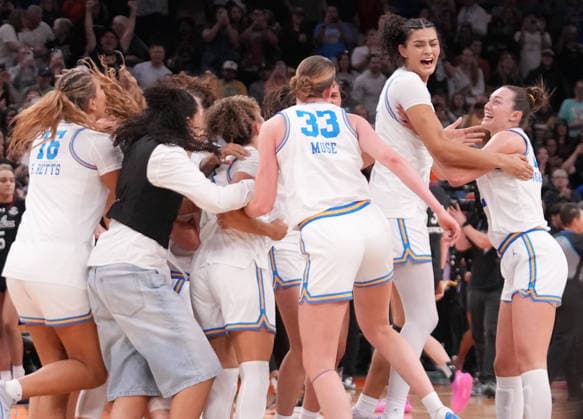 UCLA players celebrate after defeating South Carolina in the Finals of the 2026 NCAA, College League, USA Women s Basketball Tournament at Mortgage Matchup Center in Phoenix, Arizona, on Sunday, April 5, 2026. UCLA defeated South Carolina 79-51 to win their first-ever women s NCAA Tournament championship.  AZP20260405966 DARRYLxWEBB