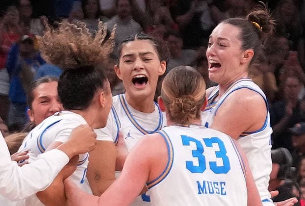 UCLA players celebrate after defeating South Carolina in the Finals of the 2026 NCAA, College League, USA Women s Basketball Tournament at Mortgage Matchup Center in Phoenix, Arizona, on Sunday, April 5, 2026. UCLA defeated South Carolina 79-51 to win their first-ever women s NCAA Tournament championship.  AZP20260405967 DARRYLxWEBB