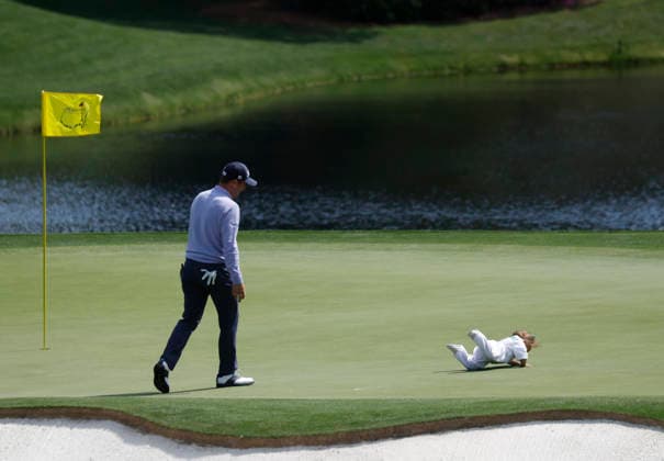 Justin Thomas watches as his daughter Molly Grace Thomas takes a tumble as they take part in the 2026 Masters golf tournament Par 3 Contest at Augusta National Golf Club in Augusta, Georgia, on Wednesday, April 8, 2026. The 2026 Masters Golf tournament begins on Thursday, April 9.  AUG20260408831 JOHNxANGELILLO