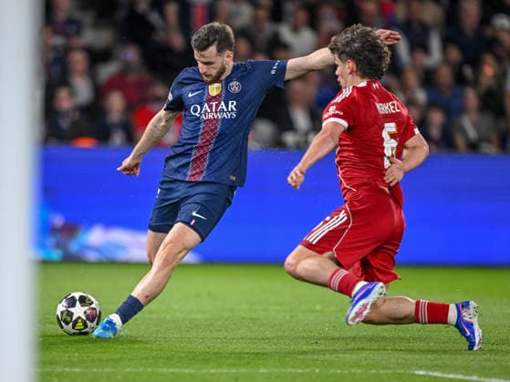 Khvicha Kvaratskhelia (Paris Saint-Germain FC) and Milos Kerkez (Liverpool FC) battle for the ball during the UEFA Champions League 2025 26 Quarter-Final First Leg match between Paris Saint-Germain FC and Liverpool FC at Parc des Princes on April 8, 2026 in Paris, France. (Photo by Harry Langer DeFodi Images) -
