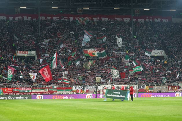 Fanblock, die Fans des FC Augsburg, GER, FC Augsburg vs. TSG 1899 Hoffenheim, Fussball, Bundesliga, 29. Spieltag, Saison 2025 2026, 10.04.2026, DFL DFB REGULATIONS PROHIBIT ANY USE OF PHOTOGRAPHS as IMAGE SEQUENCES and or QUASI-VIDEO, GER, FC Augsburg vs. TSG 1899 Hoffenheim, Fussball, Bundesliga, 29. Spieltag, Saison 2025 2026, 10.04.2026 Augsburg *** Fanblock, the fans of FC Augsburg, GER, FC Augsburg vs TSG 1899 Hoffenheim, Football, Bundesliga, Matchday 29, Season 2025 2026, 10 04 2026, DFL DFB REGULATIONS PROHIBIT ANY USE OF PHOTOGRAPHS as IMAGE SEQUENCES and or QUASI VIDEO, GER, FC Augsburg vs TSG 1899 Hoffenheim, Football, Bundesliga, Matchday 29, Season 2025 2026, 10 04 2026 Augsburg Copyright: xEibner-Pressefoto JennixMaulx EP_JML