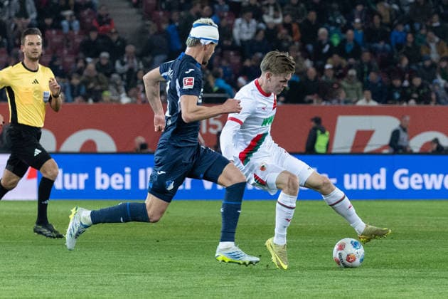 Augsburg, Deutschland 10. April 2026: 1.BL - 2025 2026 - FC Augsburg gegen TSG 1899 Hoffenheim Im Bild: v. li. im Zweikampf Albian Hajdari (TSG) und Anton Kade (FCA) DFB regulations prohibit any use of photographs as image sequences and or quasi-video. *** Augsburg, Germany 10 April 2026 1 BL 2025 2026 FC Augsburg vs TSG 1899 Hoffenheim In the picture from left in a duel Albian Hajdari TSG and Anton Kade FCA DFB regulations prohibit any use of photographs as image sequences and or quasi video Copyright: xFotostandx xStiebertx