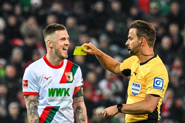 GER, 1. FBL, FC Augsburg vs TSG 1899 Hoffenheim 10.04.2026, WWK-Arena, Augsburg, GER, 1. FBL, FC Augsburg vs TSG 1899 Hoffenheim, im Bild Jeffrey Gouweleeuw (FC Augsburg, 6) redet auf Schiedsrichter Daniel Schlager ein und erhaelt anschliesend die gelbe Karte *** GER, 1 FBL, FC Augsburg vs TSG 1899 Hoffenheim 10 04 2026, WWK Arena, Augsburg, GER, 1 FBL, FC Augsburg vs TSG 1899 Hoffenheim, in the picture Jeffrey Gouweleeuw FC Augsburg, 6 talks to referee Daniel Schlager and gets a yellow card afterwards nordphotoxGmbHx xHafner nph00200