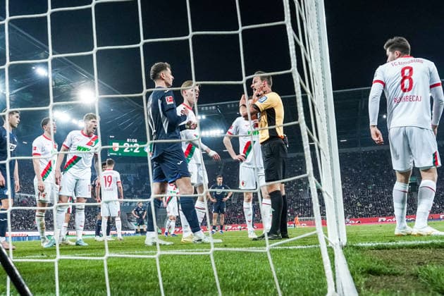 Fussball: Deutschland: 1. Bundesliga 2025 2026 - 29. Spieltag, 10.04.2026 - FC Augsburg vs. TSG Hoffenheim - WWK Arena (Augsburg, Deutschland); Schiedsrichter Daniel Schlager diskutiert mit Fisnik Asllani (TSG Hoffenheim) *** Soccer Germany 1 Bundesliga 2025 2026 Matchday 29, 10 04 2026 FC Augsburg vs TSG Hoffenheim WWK Arena Augsburg, Germany Referee Daniel Schlager discusses with Fisnik Asllani TSG Hoffenheim Copyright: xLUKAxKOLANOVICx