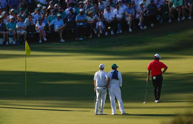 Hideki Matsuyama of Japan (R) waits to putt on the 16th green during the second day of the Masters Tournament at Augusta National Golf Club on Friday, April 10, 2026, in Augusta, Georgia.  AUG20260410856 JOHNxANGELILLO