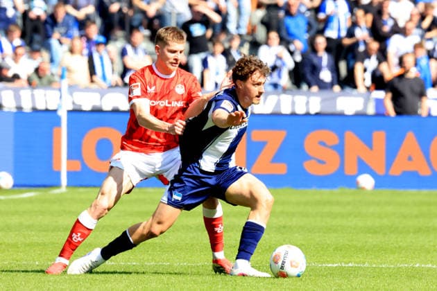 DEU, DFL, 2. FBL, Hertha BSC vs. 1.FC Kaiserslautern, 11.04.2026, Berliner Olympiastadion, Berlin, DEU, DFL, 2. FBL, Hertha BSC vs. 1.FC Kaiserslautern, im Bild Maurice Krattenmacher (Hertha BSC Berlin 14), FABIAN KUNZE (1.FC Kaiserslautern 6) DFL - regulations prohibit any use of Photographs as image sequences and or quasi-video