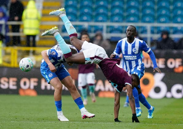Burnley, England, 11th April 2026. Florentino Luis of Burnley flies over Jack Hinshelwood of Brighton during the Burnley vs Brighton and Hove Albion Premier League match at Turf Moor, Burnley. Picture credit should read: Andrew Yates Sportimage EDITORIAL USE ONLY. No use with unauthorised audio, video, data, fixture lists, club league logos or live services. Online in-match use limited to 120 images, no video emulation. No use in betting, games or single club league player publications. SPI_026_AY_BURNLEY_BRIGHTON SPI-4677-0025