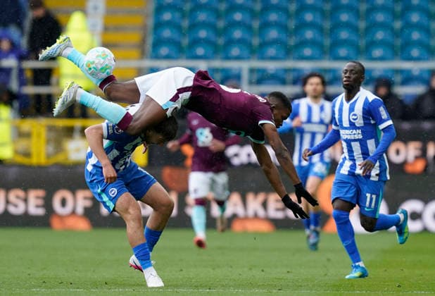Burnley, England, 11th April 2026. Florentino Luis of Burnley flies over Jack Hinshelwood of Brighton during the Burnley vs Brighton and Hove Albion Premier League match at Turf Moor, Burnley. Picture credit should read: Andrew Yates Sportimage EDITORIAL USE ONLY. No use with unauthorised audio, video, data, fixture lists, club league logos or live services. Online in-match use limited to 120 images, no video emulation. No use in betting, games or single club league player publications. SPI_027_AY_BURNLEY_BRIGHTON SPI-4677-0026