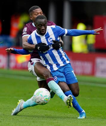 Burnley, England, 11th April 2026. Yankuba Minteh of Brighton is challenged by Florentino Luis of Burnley during the Burnley vs Brighton and Hove Albion Premier League match at Turf Moor, Burnley. Picture credit should read: Andrew Yates Sportimage EDITORIAL USE ONLY. No use with unauthorised audio, video, data, fixture lists, club league logos or live services. Online in-match use limited to 120 images, no video emulation. No use in betting, games or single club league player publications. SPI_031_AY_BURNLEY_BRIGHTON SPI-4677-0031